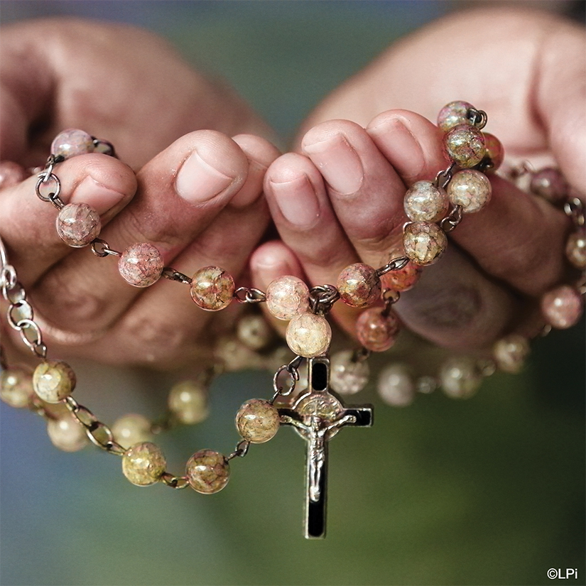 hands with rosary beads
